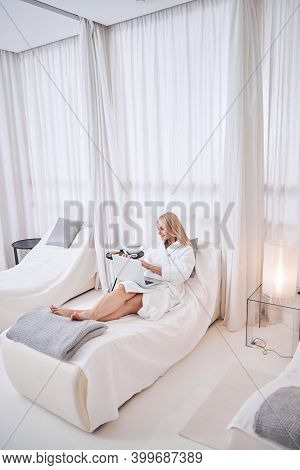 Beautiful Blonde Caucasian Female Lying On Heated Longer In Beauty Spa Salon