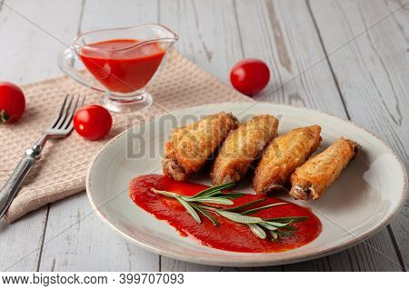 Buffolo Wings With Tomato Sauce And Rosemary Sprig