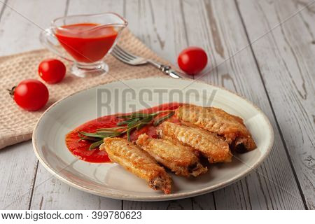 Buffolo Wings With Tomato Sauce And Rosemary Sprig