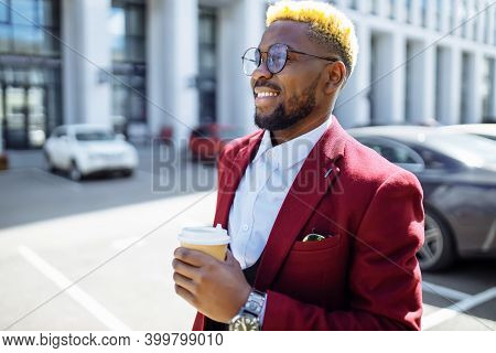 African American Man In Marsala Jacket Drinks Coffee To Go Frop Paper Eco Cup Outdoor In Centre Offi