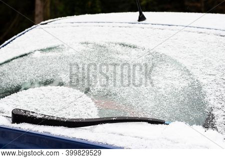 Car Windows And Wipers Covered With Snow In Winter