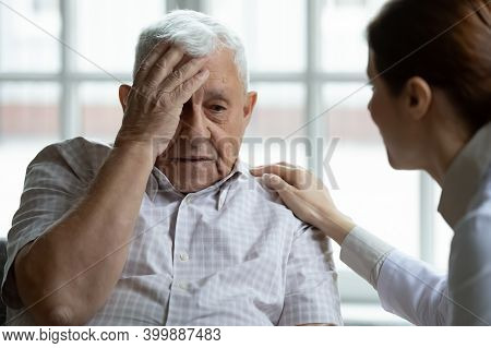Attentive Young Lady Physician Interview Senior Patient Listen To Complaints