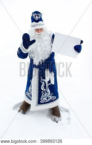 Father Frost With A Big Bag Of Gift On His Shoulder On A White Background. Santa Claus Waves His Han