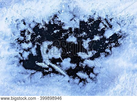 Winter Or Christmas Background Withsnow And Snowflakes Close-up On Ice, Selective Focus. Frost Patte