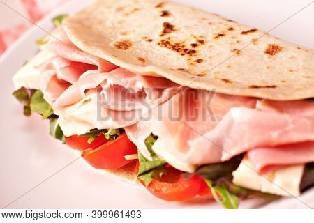 Traditional Italian Piadina With Ham, Cheese, Tomato And Salad.