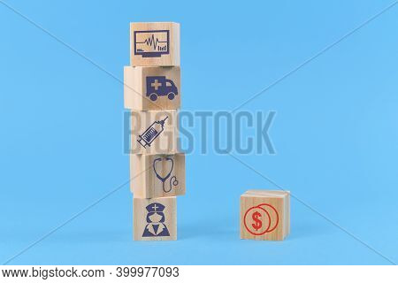 Concept For Discrepancy Between Costs For Medical Treatments And Funding Depicted With Wooden Blocks
