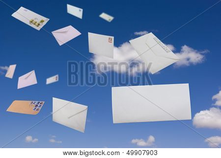 Envelopes flying against the blue sky and clouds