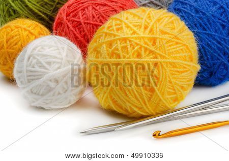Color wool skeins, knitting needles and crochet