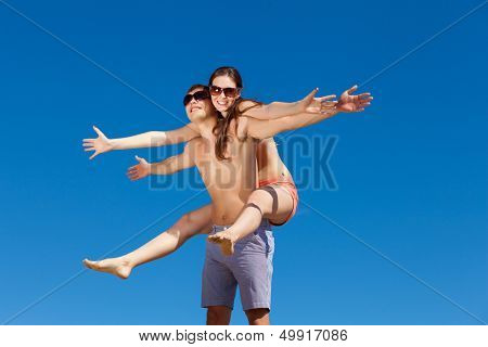 Portrait of a happy young couple enjoying at beach