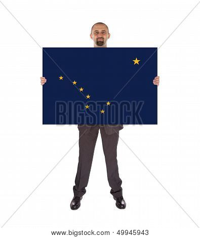 Smiling Businessman Holding A Big Card, Flag Of Alaska