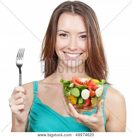 woman holding plate of fresh vegetables