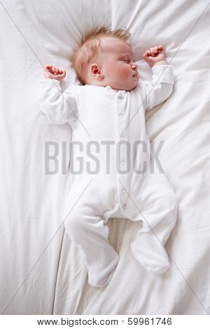 Newborn Baby Girl Sleeping In Bed