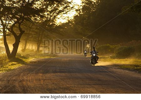 RAYONG THAILAND-AUGUST 11 : unidentified people riding motorcycle along dusty road in undevelopment