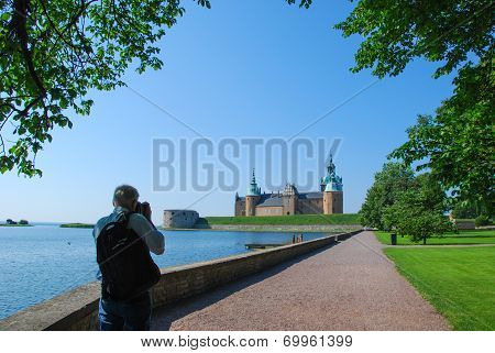 Tourist Photographing Old Castle