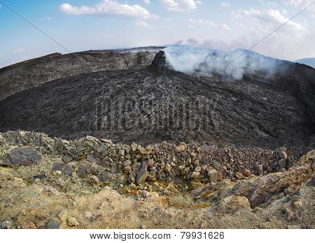 Smoking volcanic pinnacle close to Erta Ale volcano, Ethiopia
