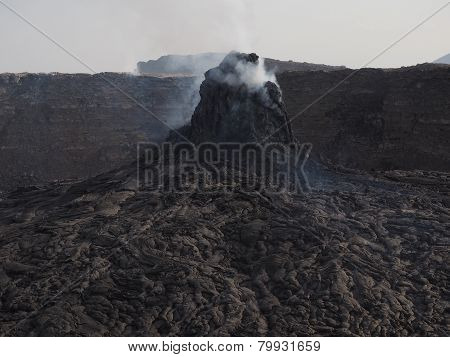 Smoking volcanic pinnacle close to Erta Ale volcano, Ethiopia