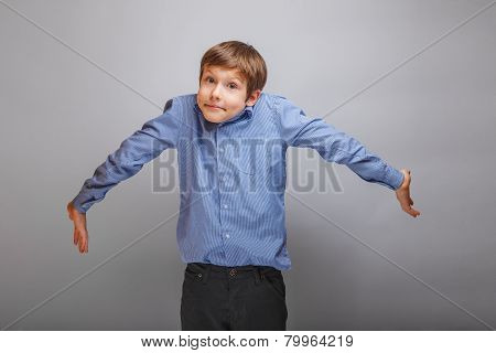 boy teenager European appearance spread his arms, ignorance, con