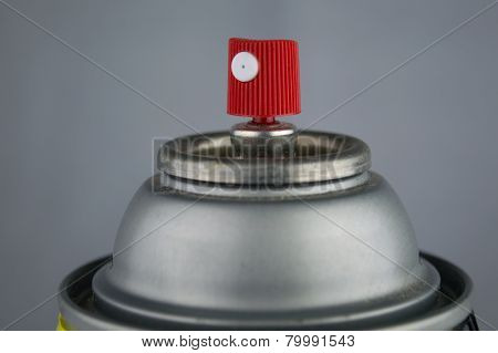 Macro Closeup Of A Red And White Nozzle On Top Of A Silver Can Of Spray Paint