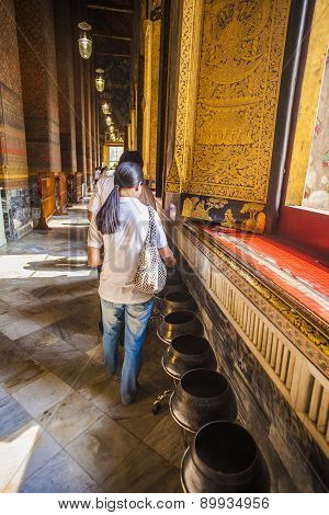 People Giving Donations In The Temple Of The Giant Reclining Buddha In Wat Pho, Thailand