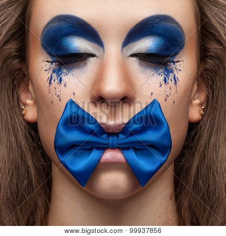 Beautiful Model With Blue Make Up And Bow In Mouth