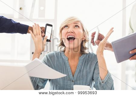 Overwrought businesswoman claiming for help at the office
