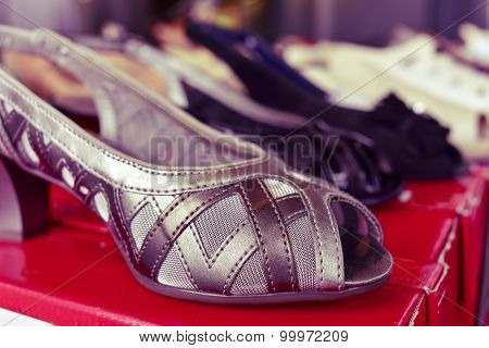 closeup of some different woman shoes on sale in a street market, with a filter effect