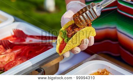 Chef making tacos at a street cafe