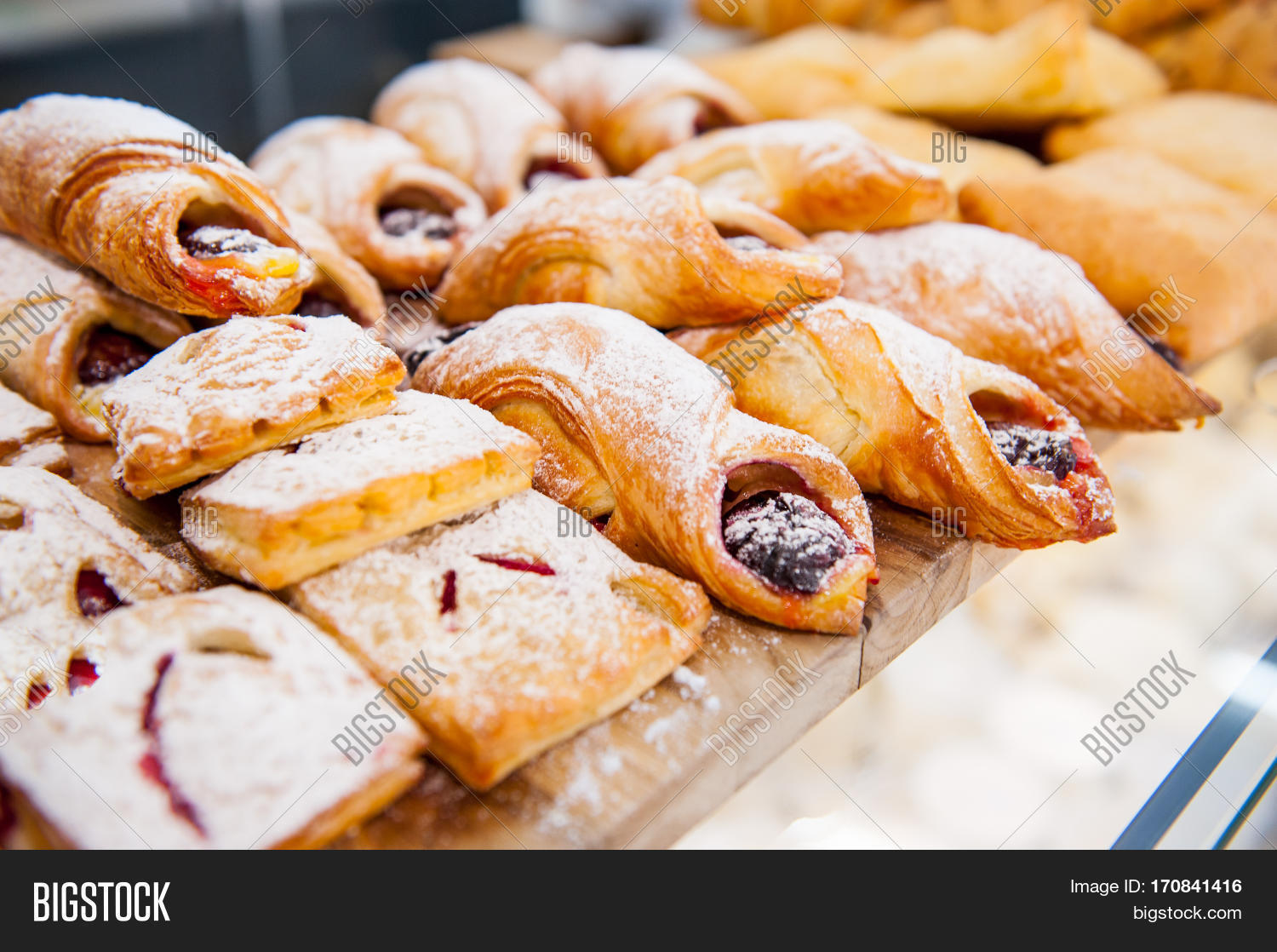 close up freshly baked pastry goods on display in bakery shop.