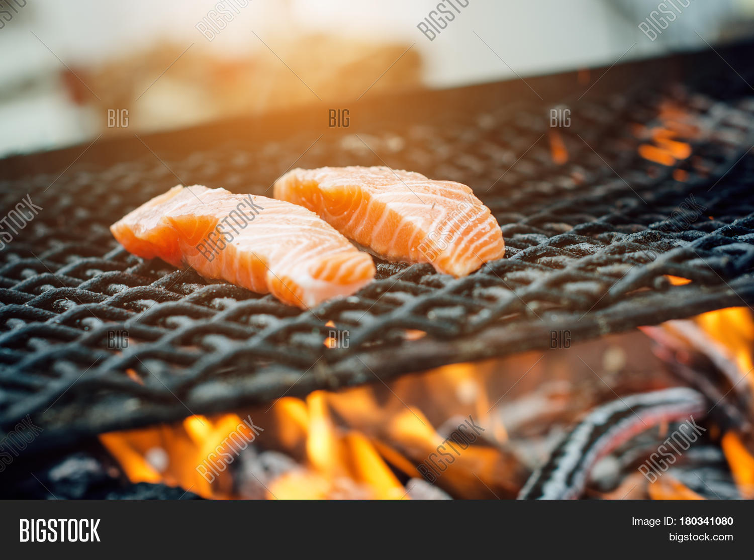grilled salmon steaks on a grill. fire flame grill.