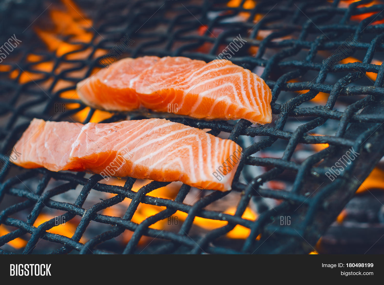 grilled salmon steaks on a grill. fire flame grill.