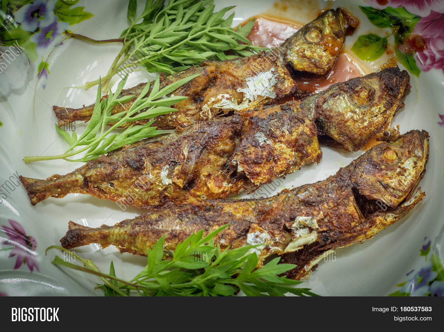 fried fish with sambal is a popular home-style dish in malaysia
