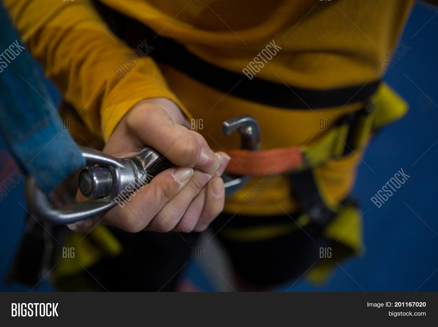 mid section of woman tightening hook in fitness studio