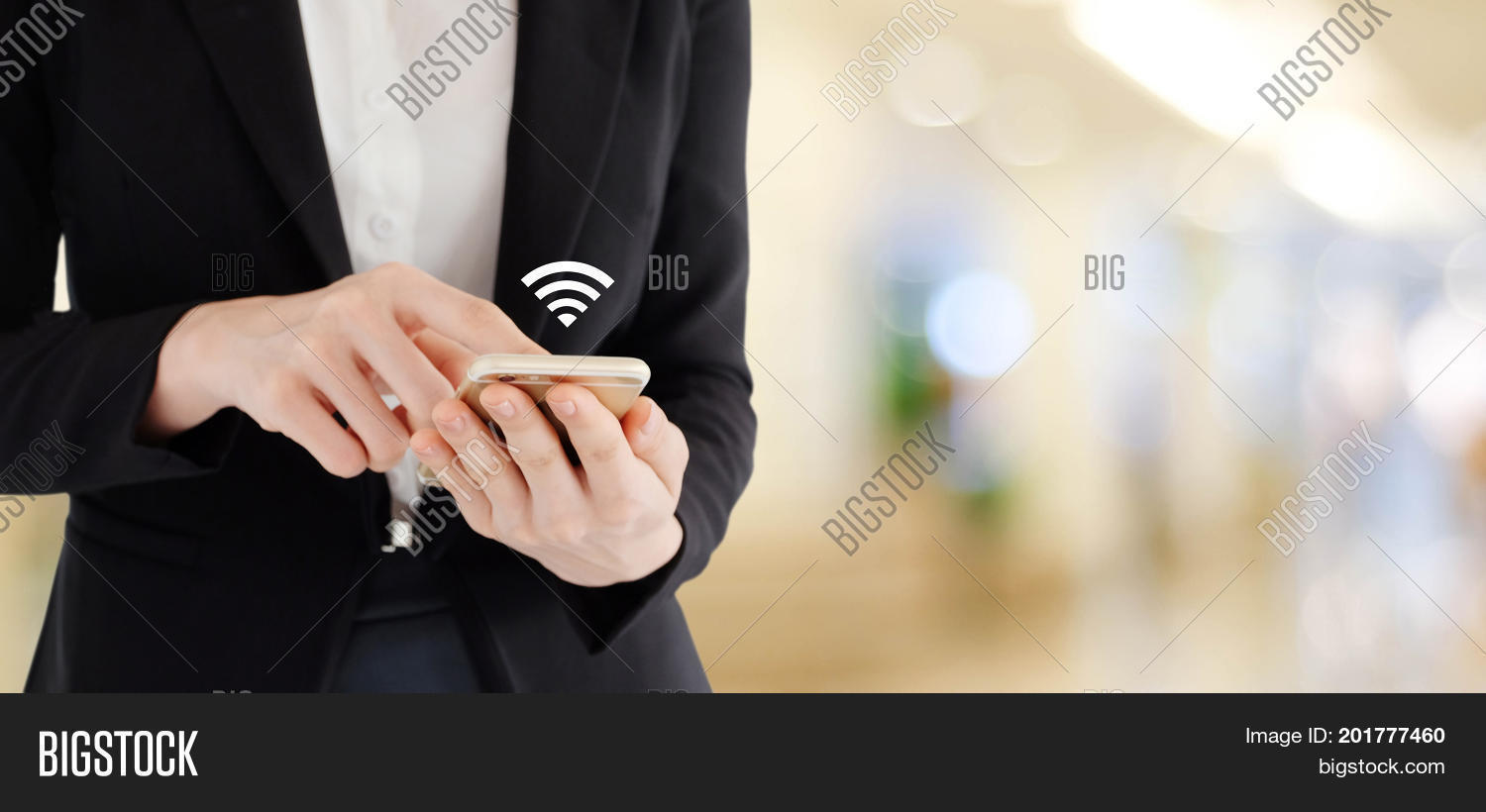 business woman hands using smart phone with wifi icon over blur