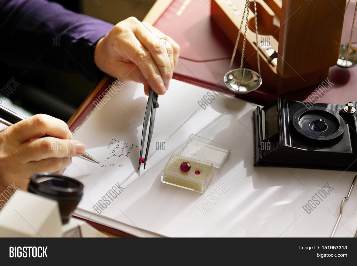 gemstone appraisal - a gemologist at work analysing and