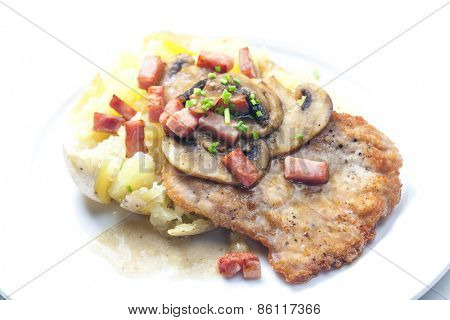 fried pork fillet with ham, mushrooms and potatoes