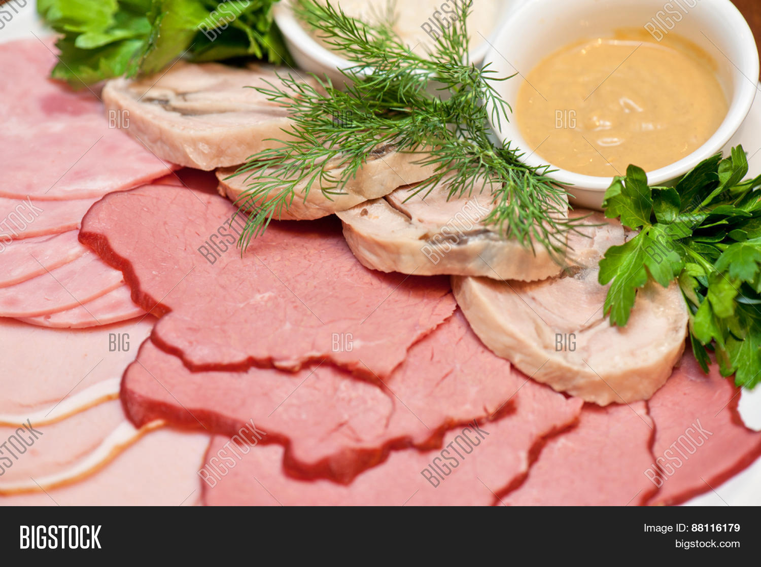 group of thin sliced meat, ham and sauce
