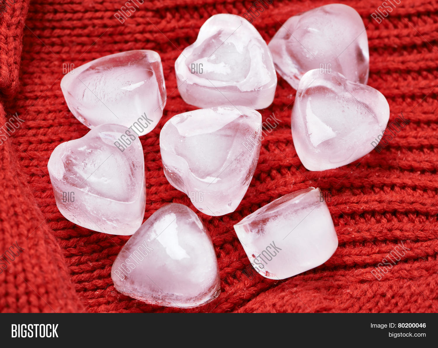 ice cubes heart on red knitted background