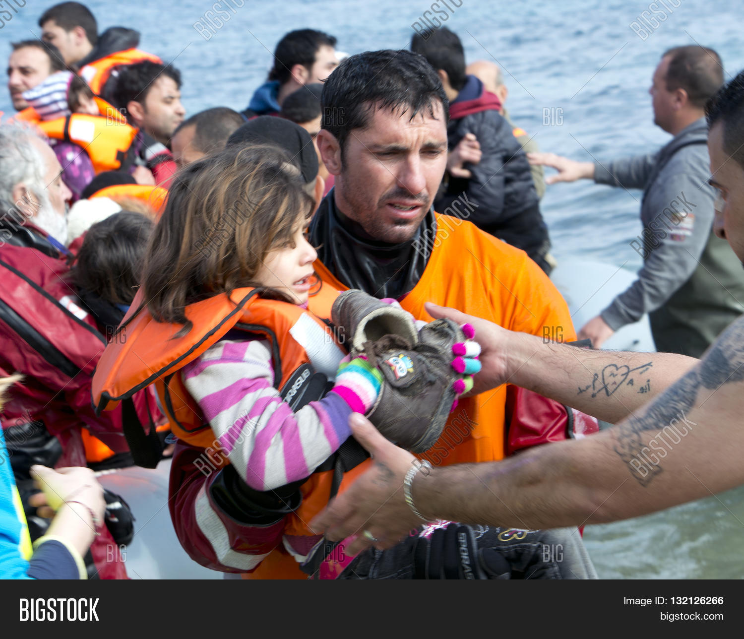 refugees arriving in greece in dinghy boat from turkey.