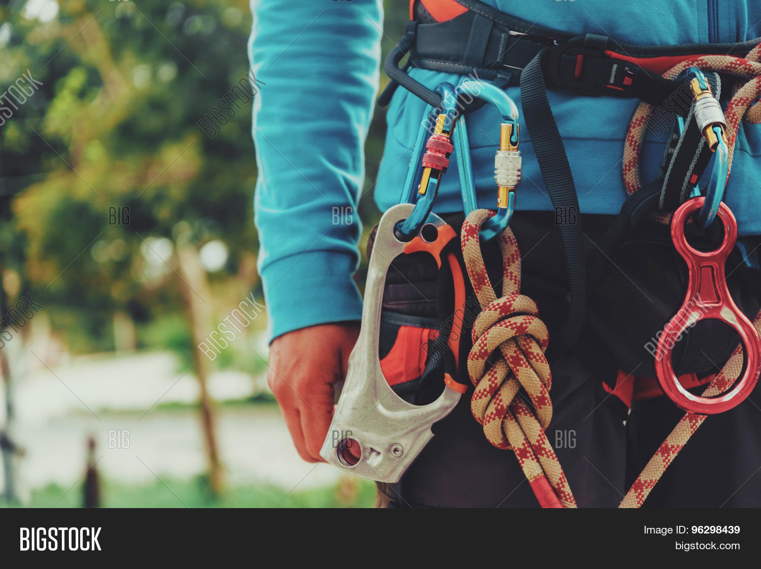 rock climber wearing safety harness and climbing equipment out