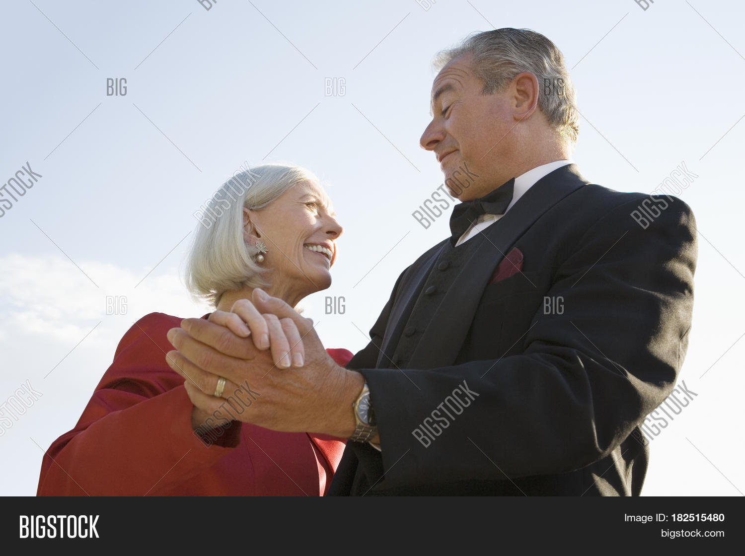 well dressed senior couple dancing outdoors