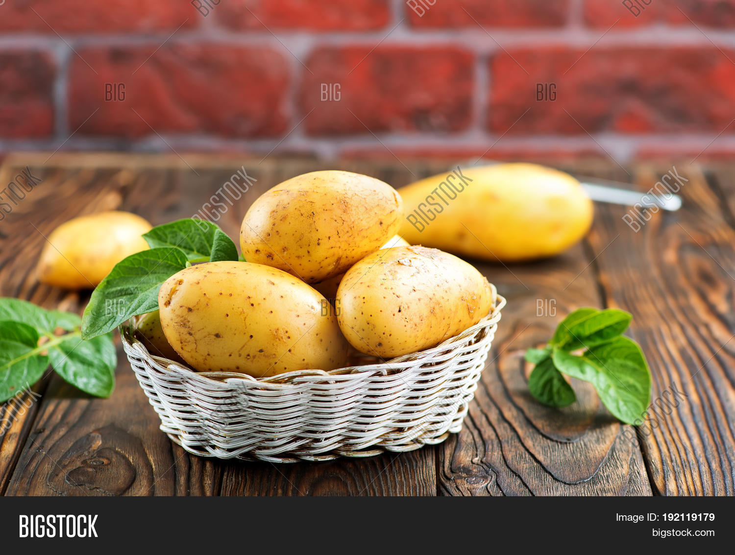 raw potato in basket and on a table