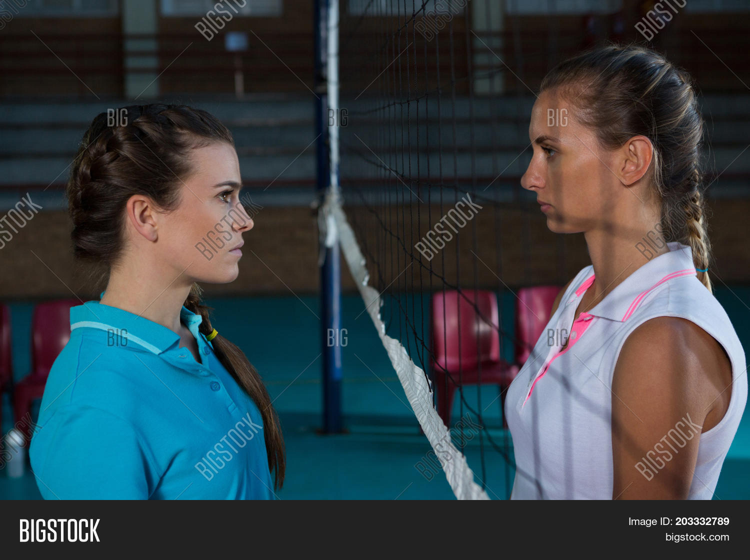 aggressive female volleyball players looking each other through