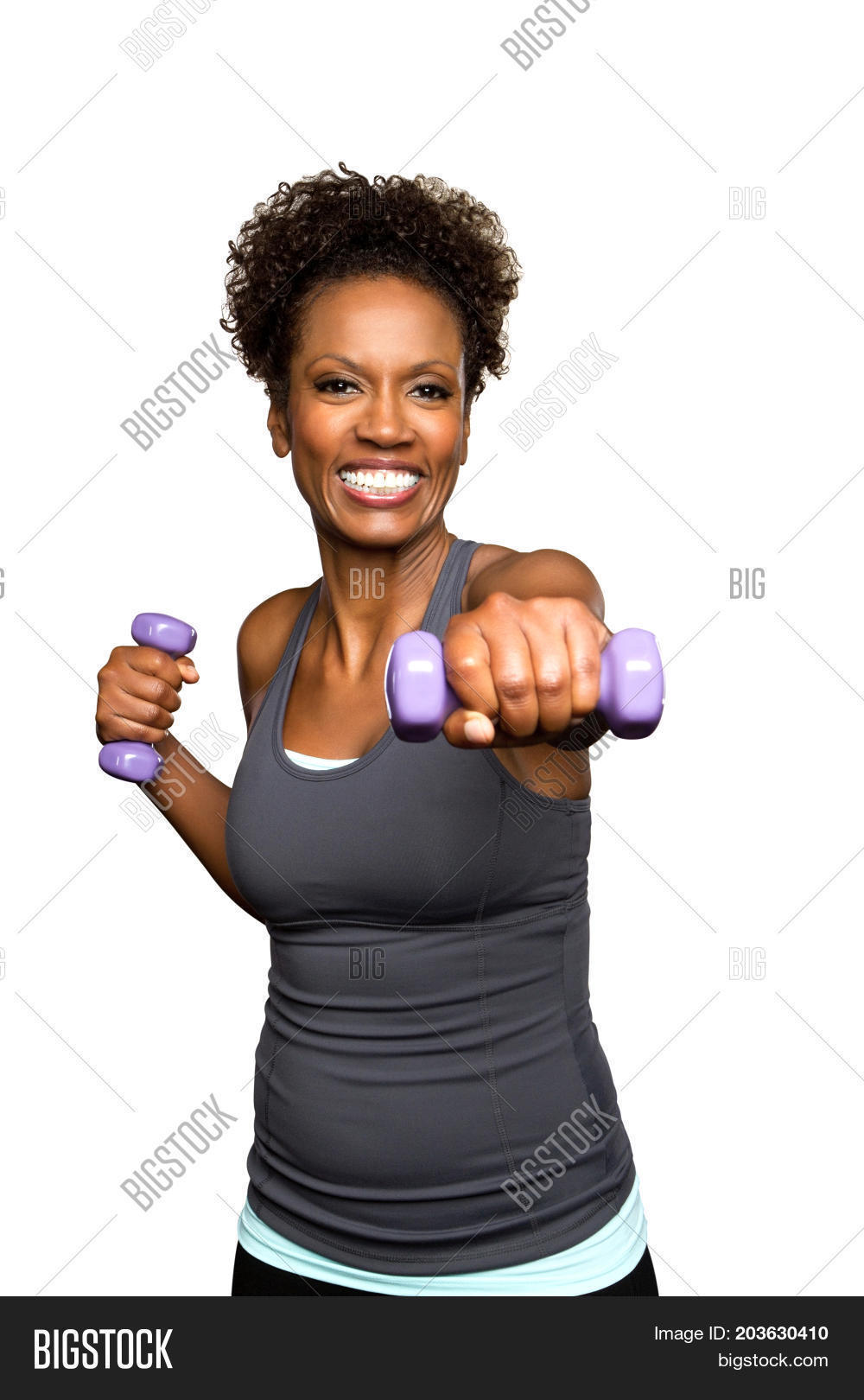 african american fit woman lifting weights smiling.