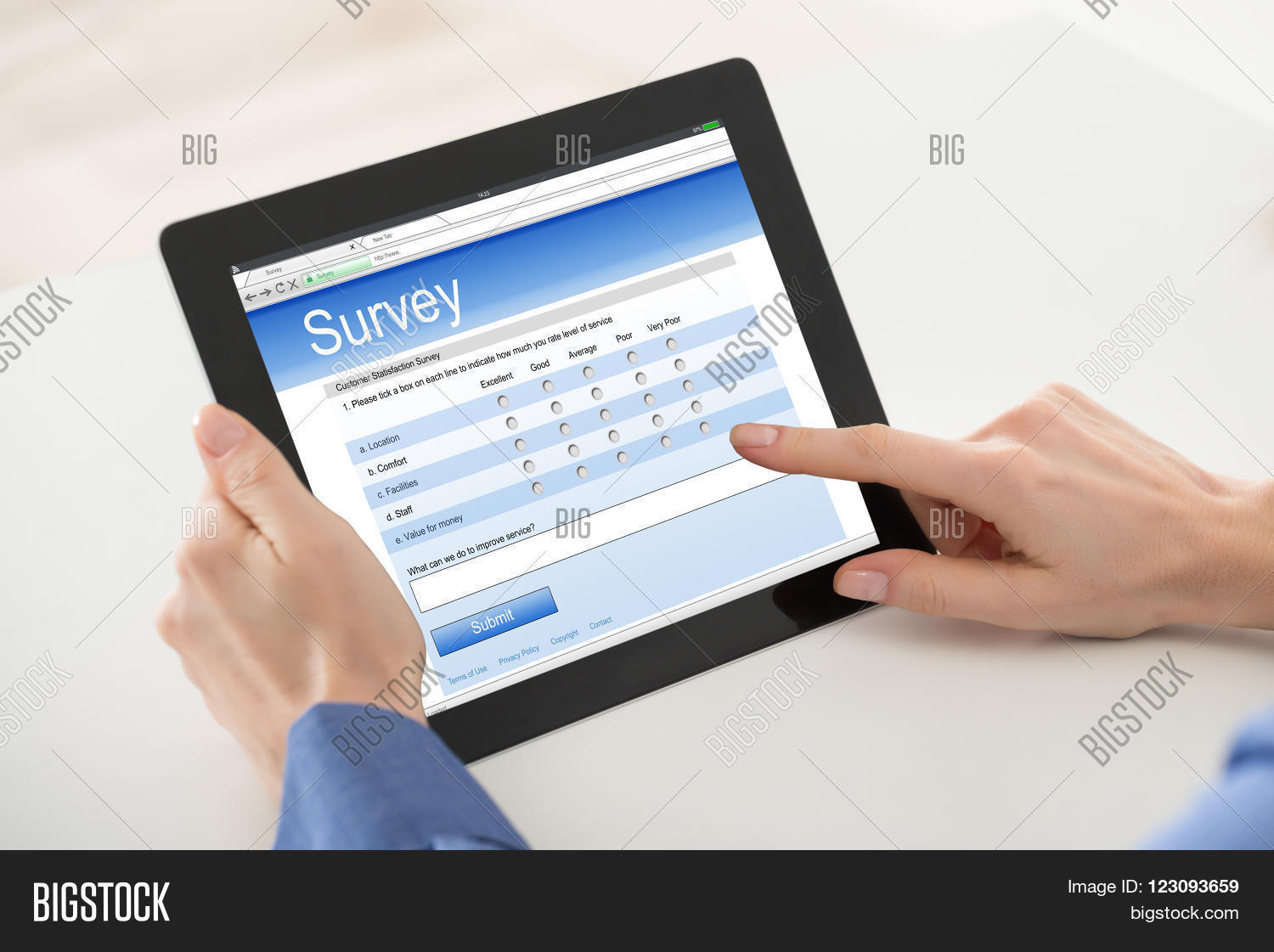 close-up of woman filling online survey form on digital tablet