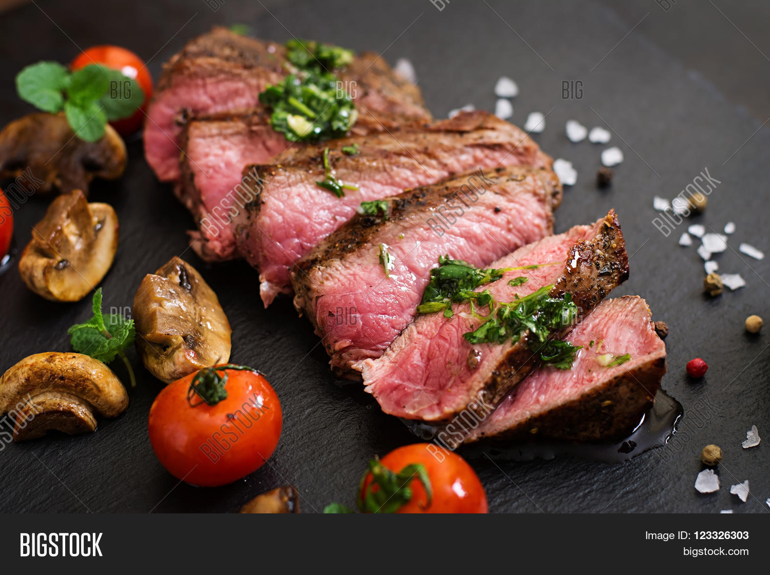 juicy steak medium rare beef with spices and grilled vegetables.