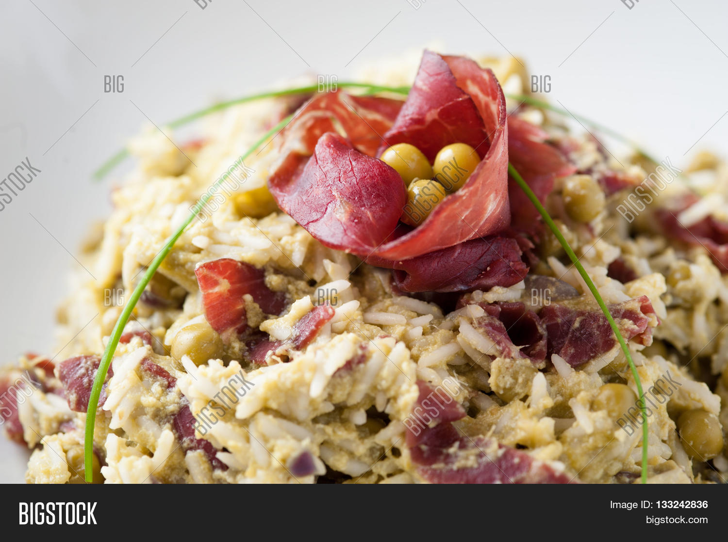 rice dish with asparagus, peas and dried beef, served on a table