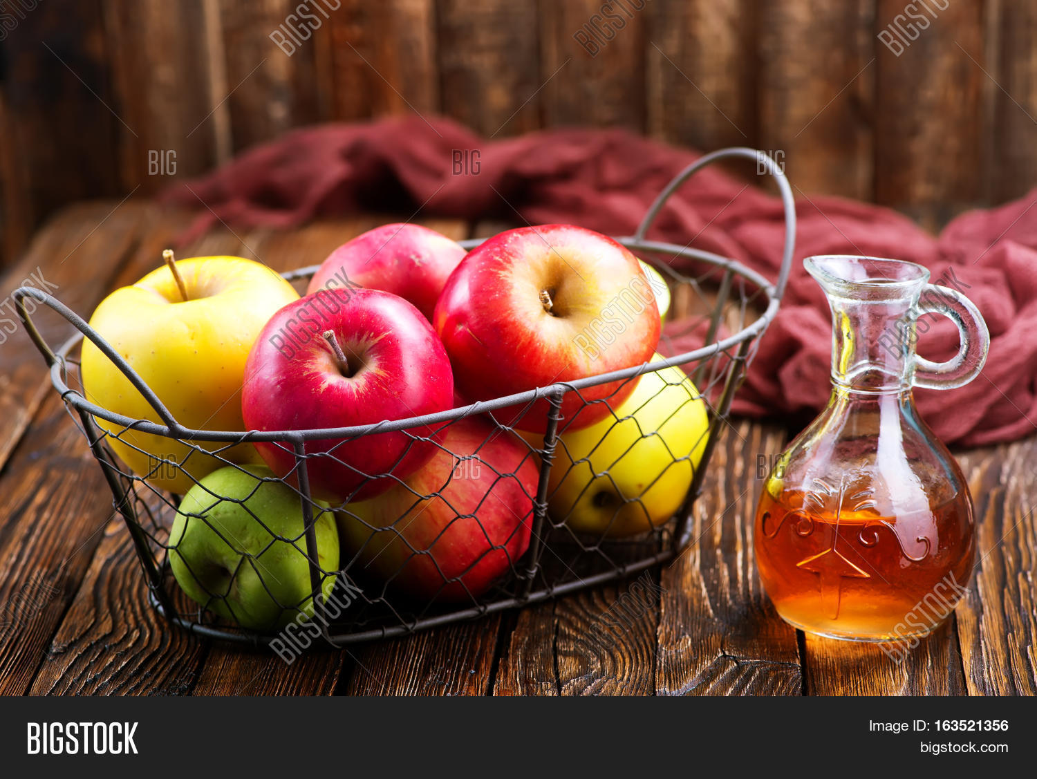 apple cider vinegar in bottle and on a table