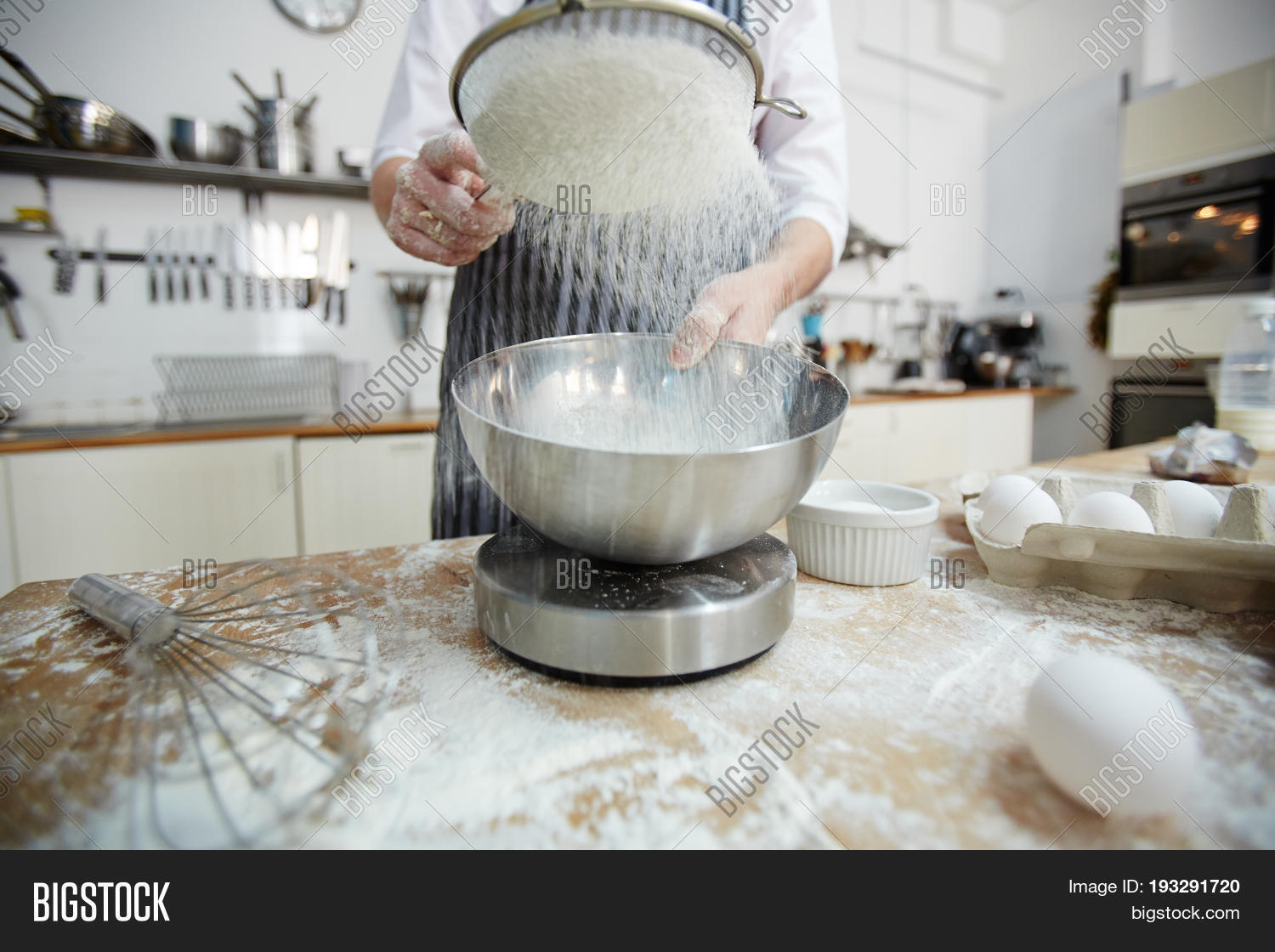 pastry-chef sifting wheaten flour for dough