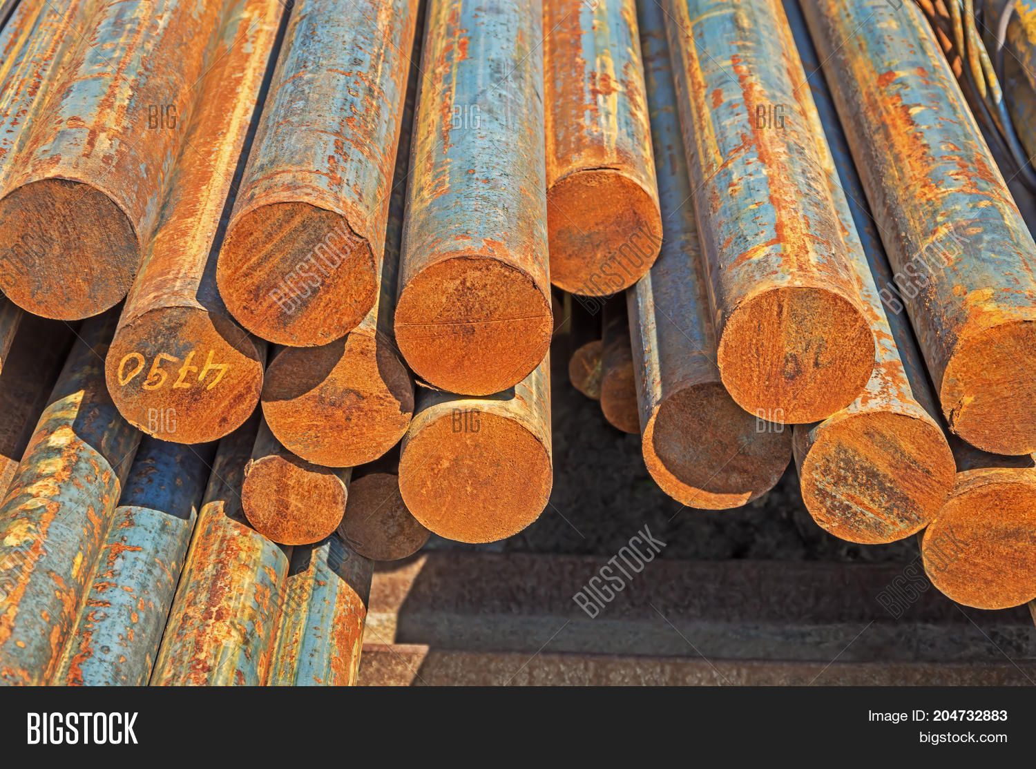 the rusty hot-rolled round steel bars in packs at the warehouse