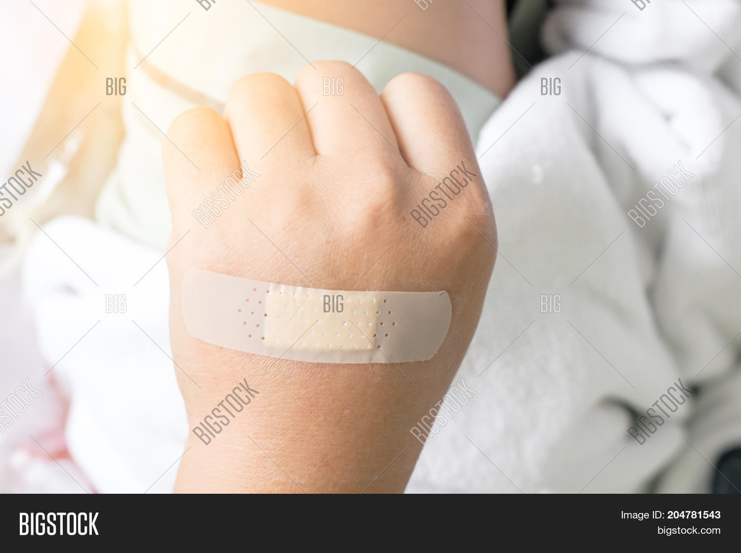 plaster close wound on back hand on the bed in hospital